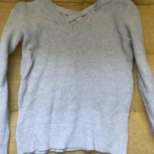 Gray sweater with crisscrossed neckline